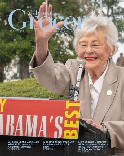 Elderly woman speaking at a public event.